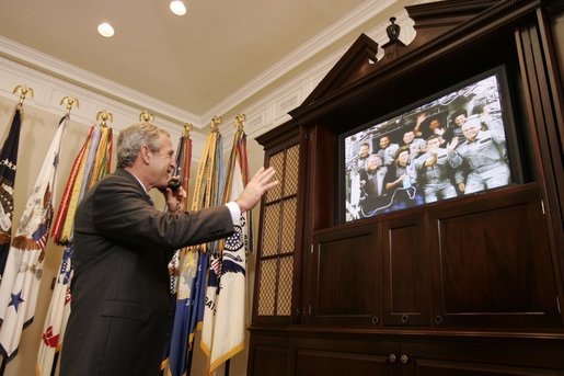  President George W. Bush smiles as he waves goodbye to the crew of the Space Shuttle Discovery Tuesday, Aug. 2, 2005, during a phone call from the Roosevelt Room of the White House. Before bidding the crew Godspeed and telling them to "get back to work," the President thanked them for being "risk-takers for the sake of exploration." White House photo by Paul Morse