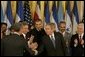 President George W. Bush shakes hands with legislators, administration officials and guests, Tuesday, Aug. 2. 2005 in the East room of the White House, after the signing ceremony for the CAFTA Implementation Act. White House photo by Krisanne Johnson