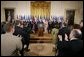 President George W. Bush acknowledges the applause of legislators, administration officials and guests, Tuesday, Aug. 2. 2005 in the East room of the White House, at the signing ceremony for the CAFTA Implementation Act. White House photo by Paul Morse