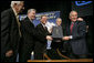 President George W. Bush holds the box containing the energy bill after signing the H.R. 6, The Energy Policy Act of 2005 at Sandia National Laboratory in Albuquerque, New Mexico, Monday, Aug. 8, 2005. Also on stage from left are Congressman Ralph Hall (R, TX), Congressman Joe Barton (R, TX), Senator Pete Domenici (R, NM) and Senator Jeff Bingaman (D, NM). White House photo by Eric Draper