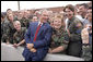 After addressing the Veterans of Foreign Wars national convention, President George W. Bush chats with troops from the Utah National Guard shortly before departing Salt Lake City, Utah, August 22, 2005. White House photo by Paul Morse