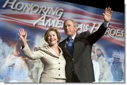 President George W. Bush and Laura Bush wave to the crowd of military families, Wednesday, Aug. 24, 2005 at the Idaho Center Arena in Nampa, Idaho, following the President's speech honoring the service of National Guard and Reserve forces serving in Afghanistan and Iraq.  White House photo by Paul Morse