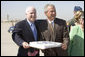 President George W. Bush joins Arizona Senator John McCain in a small celebration of McCain's 69th birthday Monday, Aug. 29, 2005, after the President's arrival at Luke Air Force Base near Phoenix. The President later spoke about Medicare to 400 guests at the Pueblo El Mirage RV Resort and Country Club in nearby El Mirage. White House photo by Paul Morse