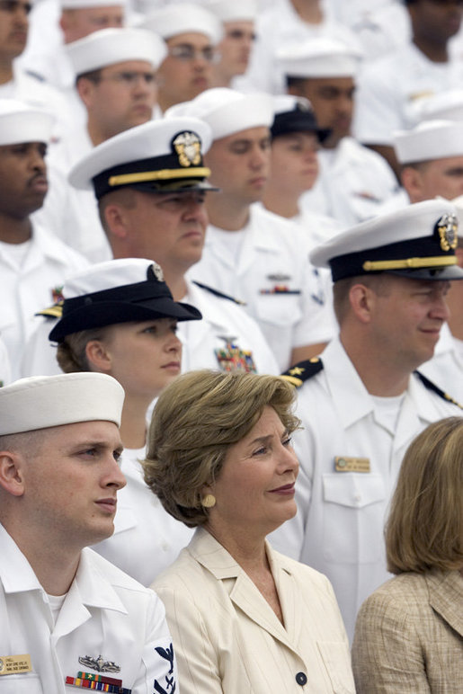 Laura Bush listens to President George W. Bush speak during a ceremony to commemorate the 60th anniversary of V-J Day at the Naval Air Station in San Diego, Calif., August 30, 2005. White House photo by Paul Morse