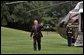 President George W. Bush waves upon arriving at the South Lawn of the White House Wednesday, August 31, 2005. This afternoon President Bush meets with his task force regarding Hurricane Katrina. White House photo by Krisanne Johnson