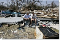 President George W. Bush spends a moment with a Patrick Wright during his walking tour Friday, Sept. 2, 2005, of Biloxi, Miss. "You know, there's a lot of sadness, of course," said the President of the devastated area. "But there's also a spirit here in Mississippi that is uplifting."  White House photo by Eric Draper