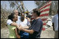 President George W. Bush embraces victims of Hurricane Katrina Friday, Sept. 2, 2005, during his tour of the Biloxi, Miss., area. " The President told residents that he had come down to look at the damage first hand and to tell the "good people of this part of the world that the federal government is going to help." White House photo by Eric Draper