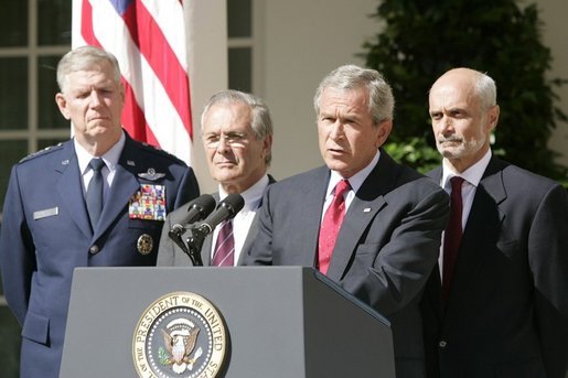 President George W. Bush speaks to the nation during a weekly radio address, live from the Rose Garden at the White House in Washington, D.C., September 3, 2005. Accompanying the president are (L to R) Chairman of the Joint Chiefs of Staff, General Richard Myers, Secretary of Defense Donald Rumsfeld and Homeland Secretary Michael Chertoff. White House photo by Paul Morse