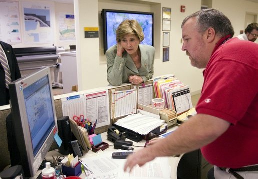 First Lady Laura Bush gets an update on the situation of efforts to help people in the aftermath of hurricane Katrina during a visit of Red Cross headquarters with President George W. Bush on Sunday September 4, 2005. White House photo by Paul Morse