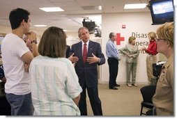 President George W. Bush talks with employees and volunteers during a visit of the Red Cross in Washington, D.C. on Sunday September 4, 2005. The President and Mrs. Laura Bush visited Red Cross headquarters to view relief efforts in the aftermath of hurricane Katrina.  White House photo by Paul Morse