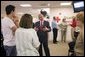 President George W. Bush talks with employees and volunteers during a visit of the Red Cross in Washington, D.C. on Sunday September 4, 2005. The President and Mrs. Laura Bush visited Red Cross headquarters to view relief efforts in the aftermath of hurricane Katrina. White House photo by Paul Morse