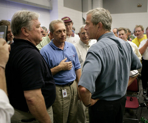 President George W. Bush talks with Mississippi Governor Haley Barbour, far left, and other state officials in Poplarville, Miss., during a visit Monday, Sept. 5, 2005 to the Gulf Coast region. White House photo by Eric Draper