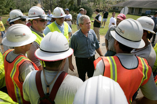 President George W. Bush talks with some workers of Alabama Power, who are helping to bring power back in service in Poplarville, Miss., Monday, Sept. 5, 2005. White House photo by Eric Draper