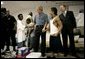 President George W. Bush visits with children inside the Bethany World Prayer Center shelter, Monday, Sept. 5, 2005 in Baton Rouge, Louisiana. The facility is housing hundreds of people displaced by Hurricane Katrina. White House photo by Eric Draper