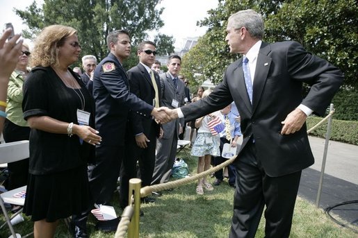 President George W. Bush shakes hands Friday, Sept. 9, 2005 with FDNY Academy graduate Tommy Gies, son of New York firefighter Lt. Ronnie Gies who died on 9/11/01, following the President's remarks at the 9/11 Heros Medal of Valor Award Cermony on the South Lawn of the White House in Washington. Gies, seen with his mother and brothers, told the President in an earlier meeting in March 2004 that it was his wish to follow in his father's footsteps. White House photo by Eric Draper