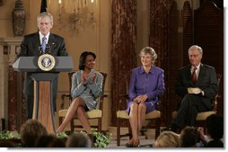 President George W. Bush addresses an audience attending the swearing-in ceremony of Karen Hughes, Friday, Sept. 9, 2005 at the State Department in Washington, to be the Under Secretary of State for Public Diplomacy. Karen Hughes is seen with U.S. Secretary of State Condoleezza Rice and her husband Jerry Hughes. White House photo by Paul Morse