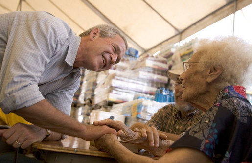 President George W. Bush visits people at a hurricane assistance center in Gulfport, Miss., Monday, Sept. 12, 2005. White House photo by Paul Morse