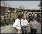 President George W. Bush is joined by Gulfport, Miss., Mayor Brent Warr, left; Twenty-Eighth Street Elementary School principal Phyllis A Bourn and Mississippi Gov. Haley Barbour, right, Monday, Sept. 12, 2005, outside the Twenty-Eighth Street Elementary School in Gulfport, where U.S. and Mexico aid workers are helping to clean-up the school devastated by Hurricane Katrina. White House photo by Paul Morse