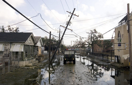 President George W. Bush tours a hurricane ravaged neighborhood in New Orleans, La., from the back of a truck with state and local officials, Monday, Sept. 12, 2005. White House photo by Paul Morse