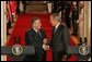 President George W. Bush shakes hands with President Jalal Talabani of Iraq after their joint press availability Tuesday, Sept. 13, 2005, in the East Room of the White House. White House photo by Shealah Craighead