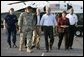 President George W. Bush arrives on the deck of the USS Iwo Jima escorted by General Russel Honore in New Orleans, La., Thursday, Sept. 15, 2005. White House photo by Eric Draper