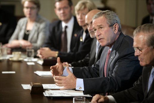 Flanked by Secretary of Defense Donald Rumsfeld and Secretary of Homeland Security Michael Chertoff, President George W. Bush speaks to members of the Homeland Security Council during a meeting Monday, Sept. 19, 2005, in the Cabinet Room of the White House. White House photo by Eric Draper