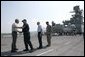 President George W. Bush is greeted by U.S. Coast Guard Vice Admiral Thad Allen, Tuesday, Sept. 20, 2005 aboard the USS Iwo Jima in New Orleans, La., joined by Rear Admiral Robert Duncan and U.S. Army Lt. General Russel Honore, right. White House photo by Eric Draper