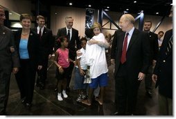 Laura Bush is greeted by three youngsters upon her arrival Monday, Sept. 19, 2005, to "Operation Compassion" at George R. Brown Convention Center in Houston.  White House photo by Krisanne Johnson