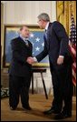 President George W. Bush congratulates Korean War era veteran Corporal Tibor " Ted" Rubin, after awarding Rubin the Medal of Honor, Friday, Sept. 23, 2005 at cermonies at the White House in Washington. Rubin was honored for his actions under fire, and his bravery while in captivity at a Chinese POW camp. White House photo by Paul Morse