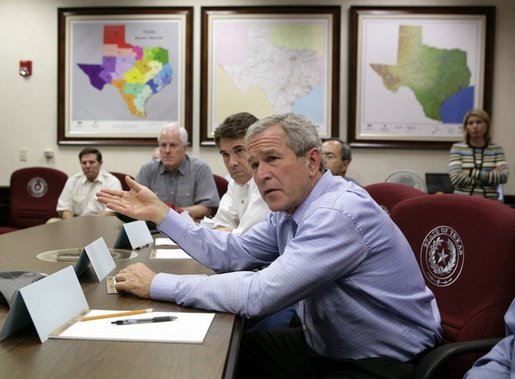 President George W. Bush speaks during a meeting with Texas officials, including Texas Governor Rick Perry, left, inside the Texas Emergency Operations Center in Austin, Texas, Saturday, Sept. 24, 2005. White House photo by Eric Draper