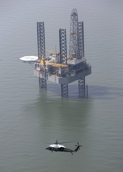 Marine One, carrying President George W. Bush, flies past an oil rig in the Gulf of Mexico near Cameron, La., during an aerial tour Tuesday, Sept. 27, 2005, of recent hurricane damage. White House photo by Eric Draper