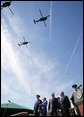 President George W. Bush stands with Defense Secretary Donald Rumsfeld during a helicopter flyover Friday, Sept. 30, 2005, during The Armed Forces Farewell Tribute in Honor of General Richard B. Myers and the Armed Forces Hail in Honor of General Peter Pace at Fort Myer's Summerall Field in Ft. Myer, Va. White House photo by Paul Morse