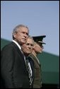 President George W. Bush stands with Defense Secretary Donald Rumsfeld during a helicopter flyover Friday, Sept. 30, 2005, during The Armed Forces Farewell Tribute in Honor of General Richard B. Myers and the Armed Forces Hail in Honor of General Peter Pace at Fort Myer, at Summerall Field in Ft. Myer, Va. White House photo by Shealah Craighead