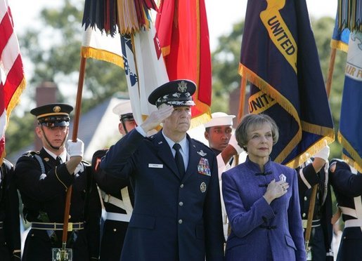 General Richard B. Myers salutes as he stands with his wife, Mary Jo Myers, Friday, Sept. 30, 2005, during ceremonies at theThe Armed Forces Farewell Tribute in Honor of General Richard B. Myers and the Armed Forces Hail in Honor of General Peter Pace at Fort Myer's Summerall Field in Ft. Myer, Va. White House photo by David Bohrer