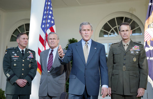 President George W. Bush addresses the media Wednesday, Oct. 5, 2005, in the Rose Garden, flanked by Gen. David Petraeus, former Commander of the Multinational Security and Transition Team in Iraq; Secretary of Defense Donald Rumsfeld, and Gen. Peter Pace, Chairman of the Joint Chiefs of Staff. White House photo by Paul Morse