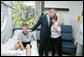 President George W. Bush hugs Anita Kukkola, the mother of PFC. Jason Kukkola of Fountain Hills, Ariz., Wednesday, Oct. 5, 2005, after he presented the soldier with a Purple Heart during a visit to Walter Reed Army Medical Center in Washington D.C. White House photo by Paul Morse