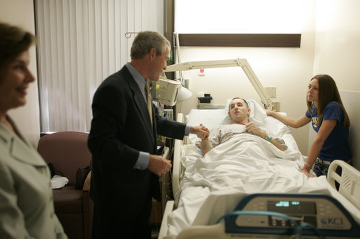 President George W. Bush shakes the hand of SPC Jeremy Goodman of Washington, N.C., as his wife, Terry Goodman, looks on Wednesday, Oct. 5, 2005, during a visit by the President and Mrs. Bush to Walter Reed Army Medical Center in Washington D.C. White House photo by Paul Morse