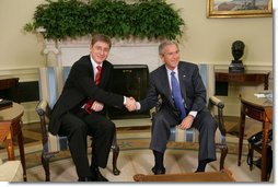 President George W. Bush and Prime Minister Ferenc Gyurcsany of Hungary shake hands during a photo opportunity in the Oval Office of the White House Friday, Oct. 7, 2005. The President told the media he appreciated the Prime Minister's understanding of the "importance of democracy and freedom," and thanked him for his leadership. White House photo by Paul Morse