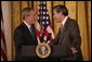 President George W. Bush thanks U.S. Commerce Secretary Carlos Gutierrez for his introduction in the East Room of the White House, Friday, Oct. 7, 2005, as President Bush prepares to address remarks in celebration of Hispanic Heritage Month. President Bush also honored recipients of the President's Volunteer Service Awards at the event. White House photo by Eric Draper