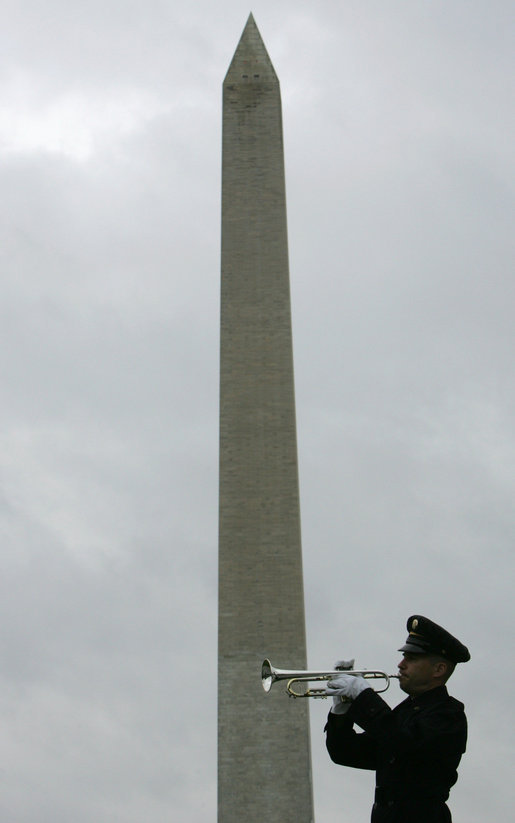 A soldier plays taps upon the conclusion of a wreath-laying ceremony at the National World War II Memorial Friday, Oct. 7, 2005, in Washington D.C., where Vice President Dick Cheney remarked, ".You served honorably in a desperate era for our country. And in pivotal hours of the Second World War, the 526th Armored Infantry Battalion was a valiant unit.One of the great strengths of this country is the unselfish courage of the citizen who steps forward, puts on the uniform, and stands ready to go directly into the face of danger." The ceremony was in honor of the 526th Armored Infantry Battalion which is the sole remaining, separate armored infantry battalion from World War II, whose soldiers defended the Belgian villages of Stavelot and Malmedy on December 16, 1944, the first day of the Battle of the Bulge. White House photo by David Bohrer