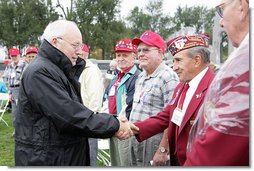 Vice President Dick Cheney shakes hands with veterans of the 526th Armored Infantry Battalion Friday, Oct. 7, 2005, after delivering remarks during a wreath-laying ceremony at the National World War II Memorial in Washington D.C. "I count it a privilege to stand in the presence of men who were sent into battle by President Franklin D. Roosevelt.and who, by your courage and honor and devotion to duty, helped to win a war and change the course of history ," said the Vice President to the soldiers, widows and family members who attended the ceremony. The 526th AIB is the sole remaining, separate, armored infantry battalion from World War II whose soldiers defended the Belgian villages of Stavelot and Malmedy on December 16, 1944, the first day of the Battle of the Bulge.  White House photo by David Bohrer