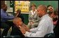 Laura Bush watches fathers play a game with their children in the R.E.A.D. to Kids Training Program at J.S. Chick Elementary School in Kansas City, Mo., Tuesday, October 11, 2005. White House photo by Krisanne Johnson