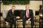 President George W. Bush and Poland's President Aleksander Kwasniewski shake hands as they meet with reporters in the Oval Office at the White House, Wednesday, Oct. 12, 2005 in Washington. White House photo by Eric Draper