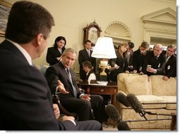 President George W. Bush gestures to Bulgarian President Georgi Purvanov as they take questions from reporters, Monday, Oct. 17, 2005, in the Oval Office at the White House in Washington.  White House photo by Eric Draper