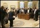 President George W. Bush poses for photos, Tuesday, Oct. 25, 2005 with the 2005 National Physical Fitness Champions, during their visit to the Oval Office at the White House. White House photo by Eric Draper