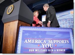 President George W. Bush shakes the hand of Jonnie Nance, chairman of the Joint Armed Forces Officers' Wives Luncheon, after being introduced by her Tuesday, Oct. 25, 2005, at the Bolling Air Force Base Officers' Club in Washington, D.C. The President told the audience that he understood it was a trying time for military spouses, adding: "By standing behind those who serve, you're serving, as well."  White House photo by Paul Morse