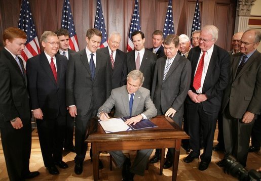 President George W. Bush is joined by legislators, Wednesday, Oct. 26, 2005 at the Eisenhower Executive Office Building in Washington, as he signs the Protection of Lawful Commerce in Arms Act. White House photo by Paul Morse