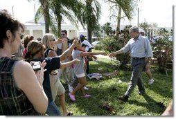 President George W. Bush greets local residents lined up at a food and water distribution center, Thursday, Oct. 27, 2005, in the hurricane damaged area of Pompano Beach, Fla.  White House photo by Eric Draper