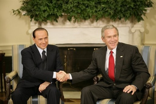 President George W. Bush shakes hands with Italian Prime Minister Silvio Berlusconi, during his visit to the Oval Office at the White House, Monday, Oct. 31, 2005 in Washington. White House photo by Eric Draper