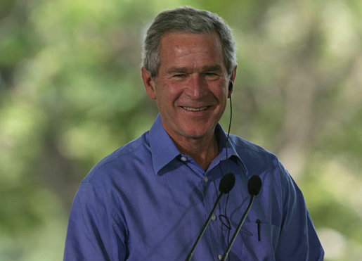 President George W. Bush smiles as he listens through an earpiece to a translation of the remarks by Brazil President Luiz Inacio Lula da Silva Saturday, Nov. 6, 2005, in Brasilia, Brazil. White House photo by Paul Morse